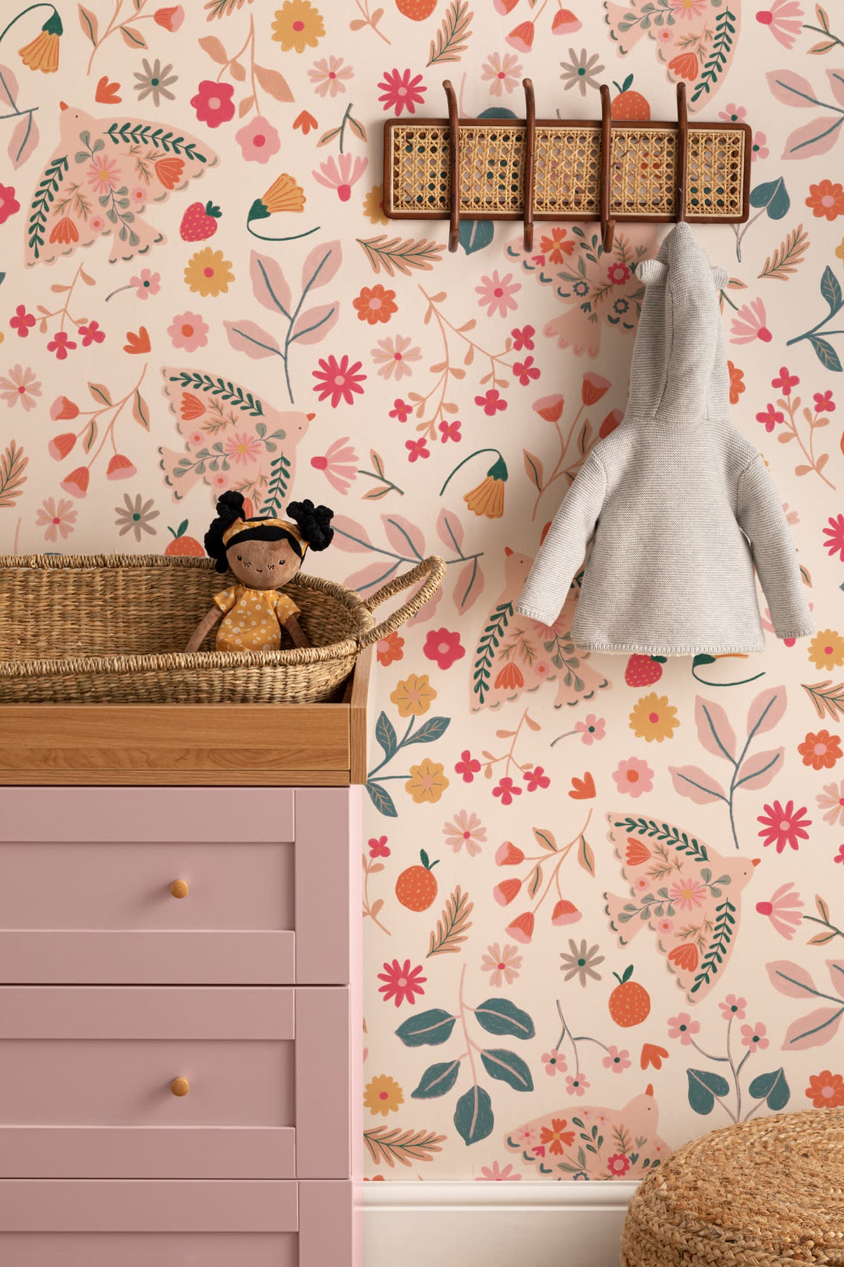 The Songbird Parterre wallpaper in blush and coral on a nursery wall