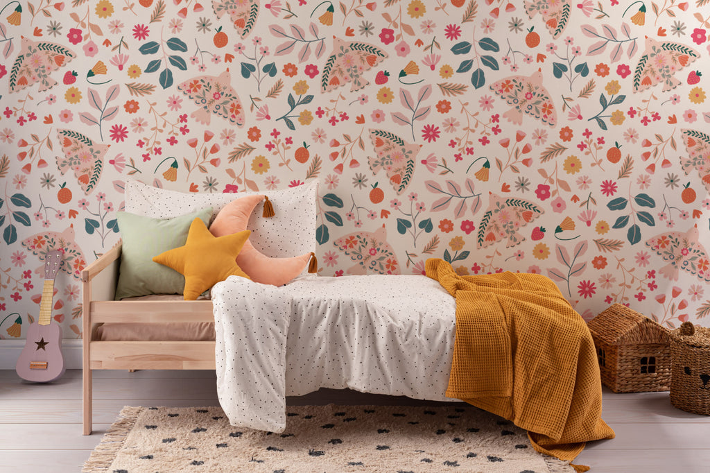 The Songbird Parterre wallpaper in blush and coral behind the bed in a bedroom