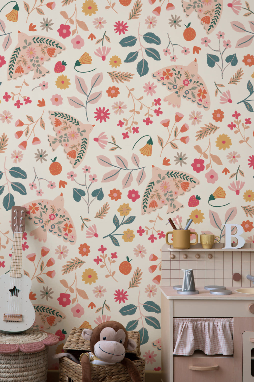 The Songbird Parterre wallpaper in blush and coral in a child's bedroom