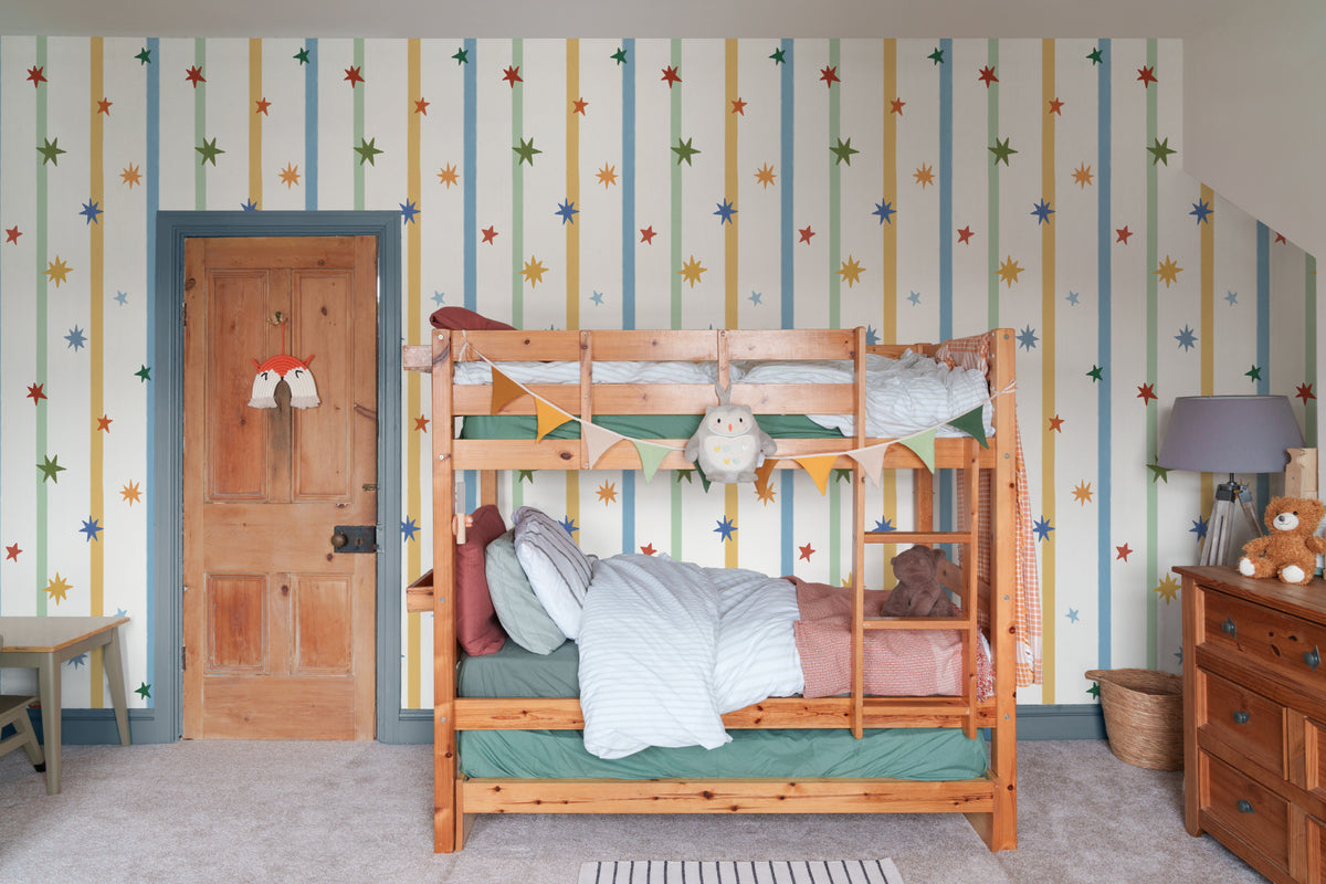 The Star Ribbon mural in sunflower and sky behind a kids' play corner