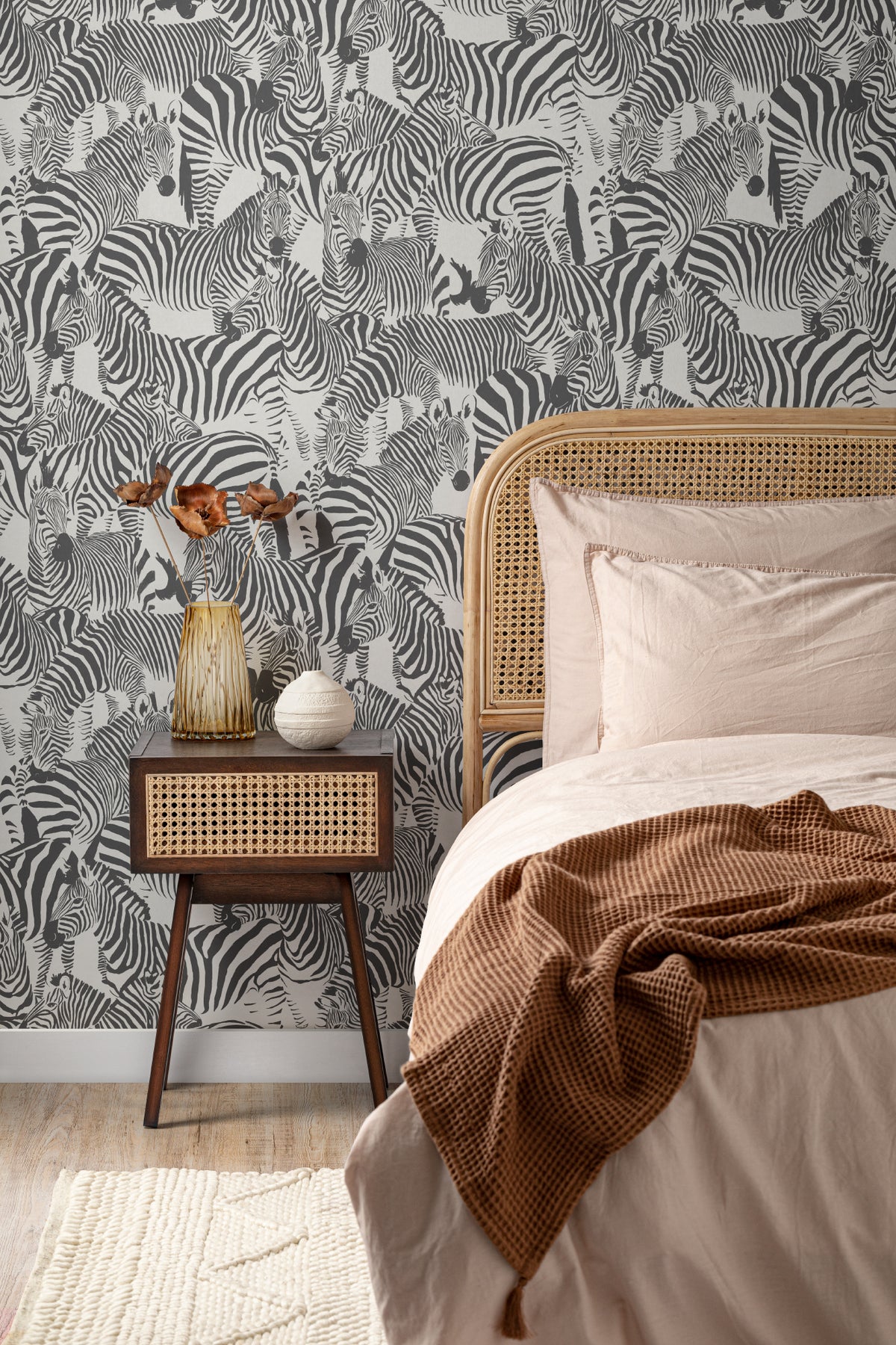 The Striped Herd wallpaper in black and white behind the bed in a bedroom