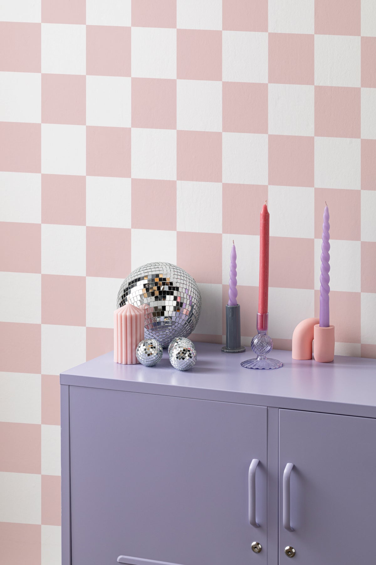 The Sugar Check wallpaper in candy pink and white behind a kids' play corner