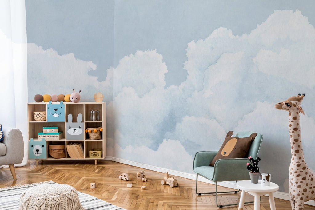 The Summer Cloudscape mural in pastel sky blue behind a kids' play corner