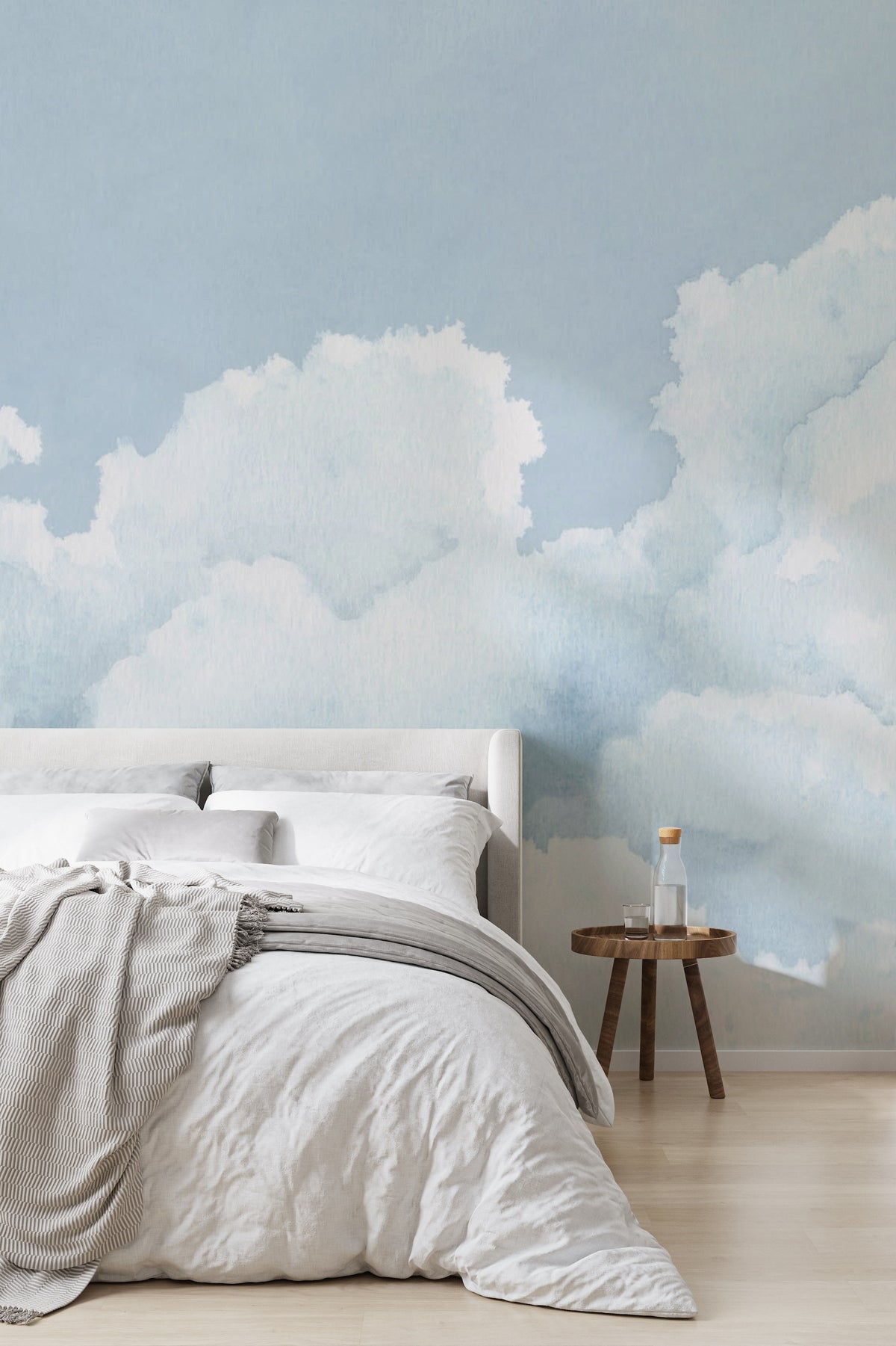 The Summer Cloudscape mural in pastel sky blue behind the bed in a bedroom