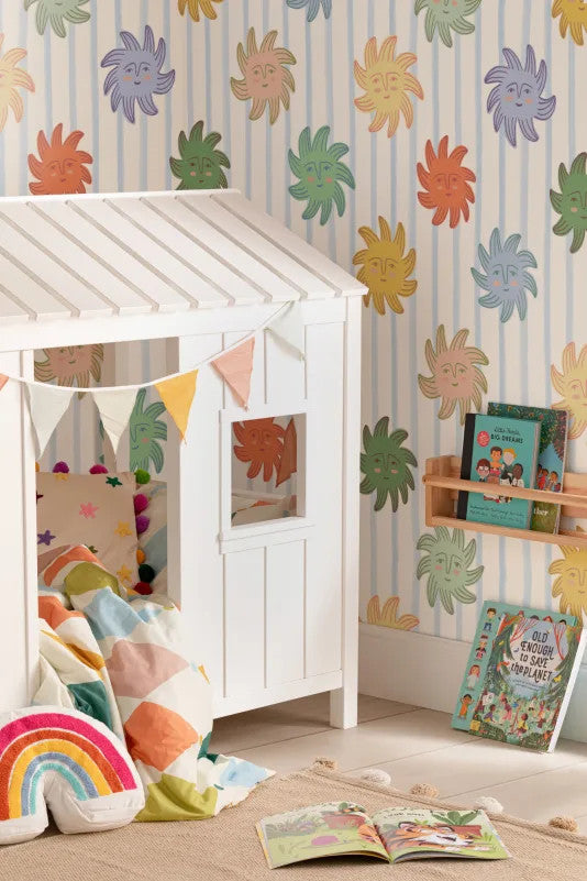 The Sunbeam Stripe wallpaper in duck egg and sunshine behind a kids' play corner