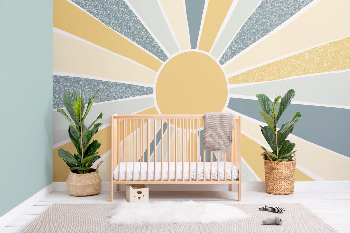 The Sunburst Morning mural in dusty blue and mustard on a nursery wall
