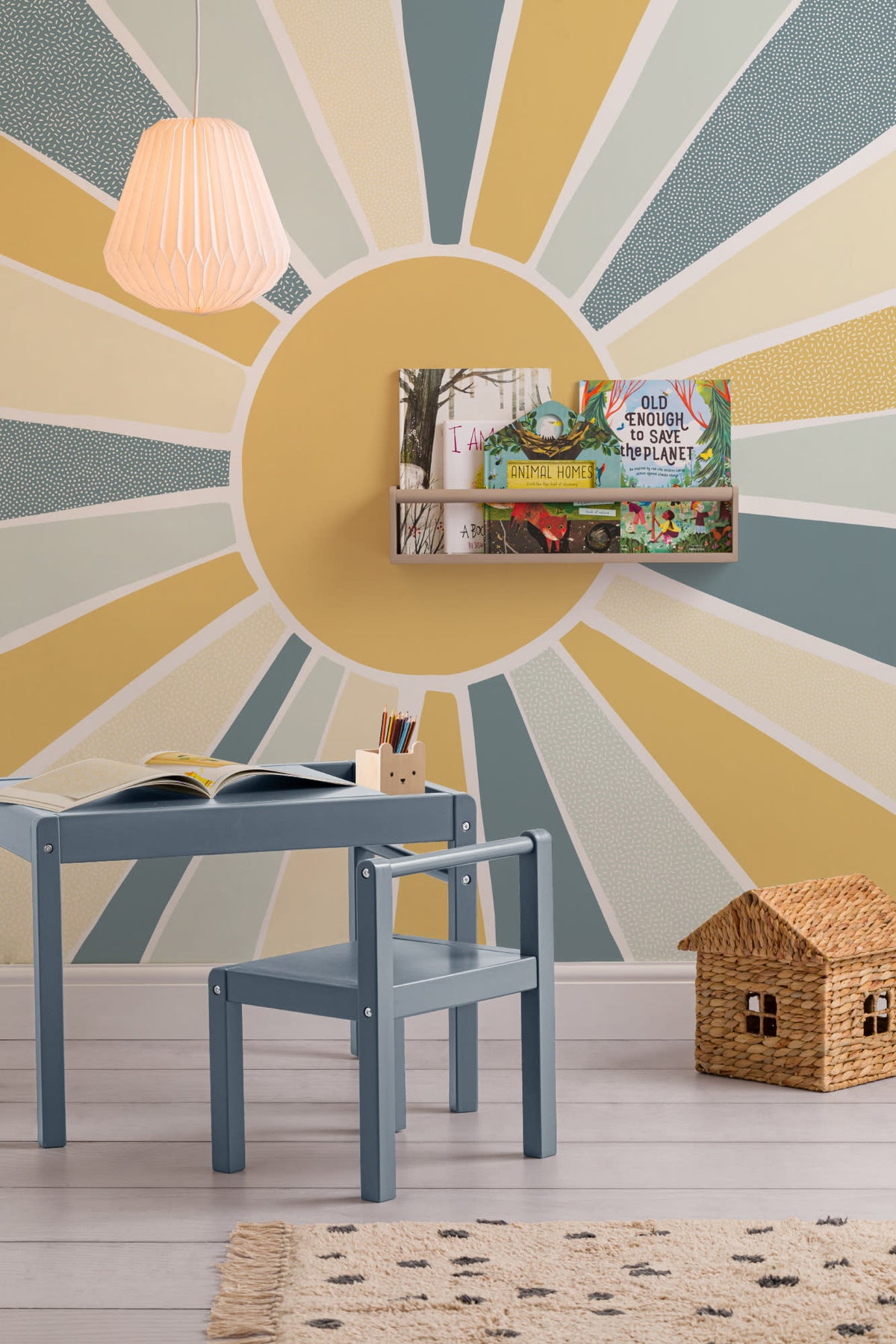 The Sunburst Morning mural in dusty blue and mustard in a child's bedroom