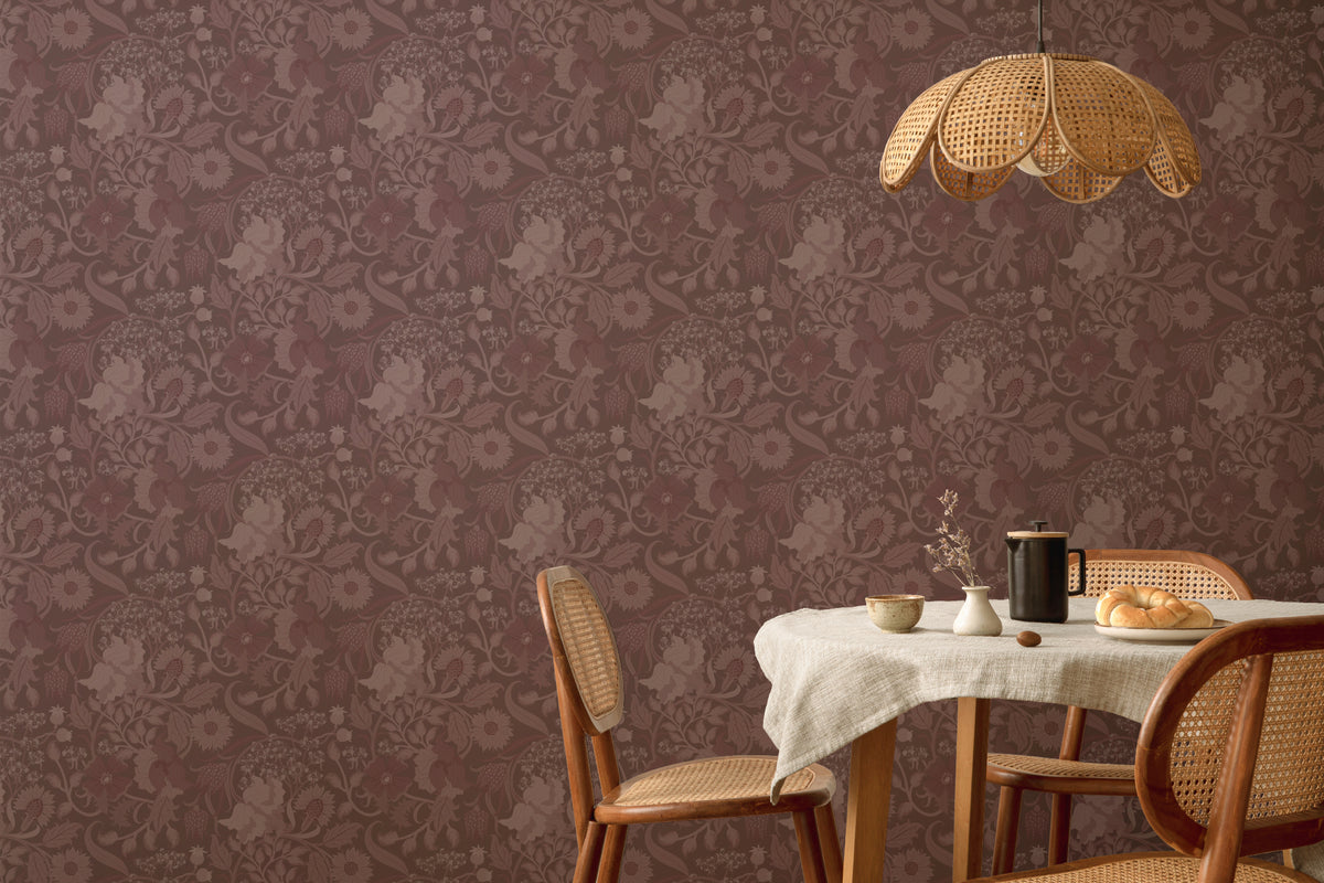 The Thistle Manor wallpaper in mulberry plum behind a dining table