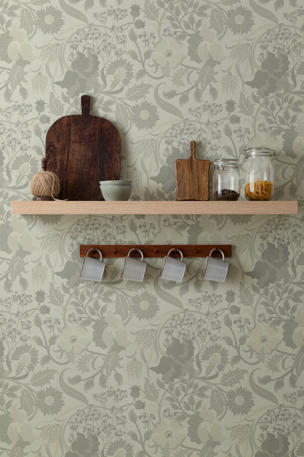 The Thistle Manor wallpaper in sage green behind a styled console
