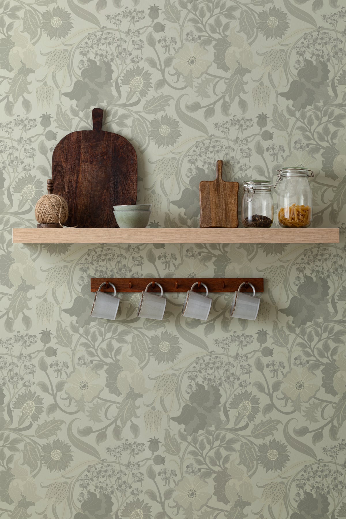 The Thistle Manor wallpaper in sage green behind a styled console