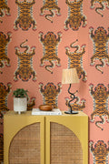 The Tiger Court wallpaper in coral and amber behind a styled console