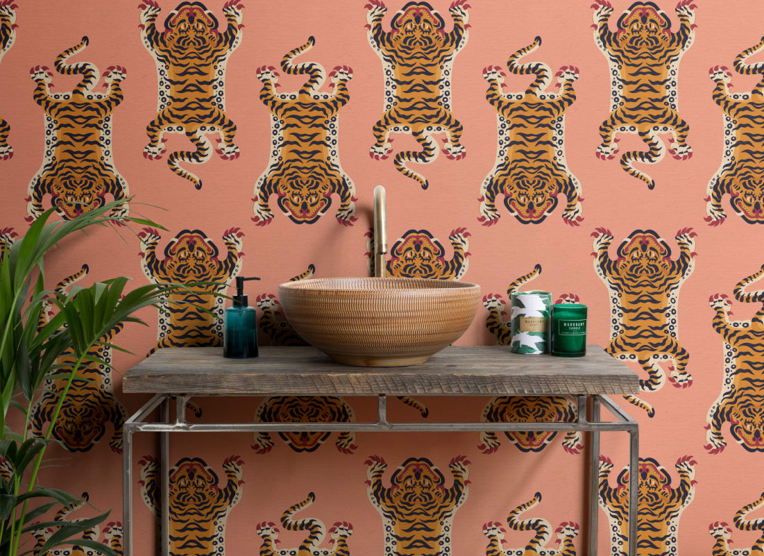 The Tiger Court wallpaper in coral and amber in a living room