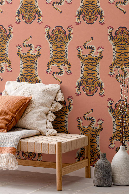 The Tiger Court wallpaper in coral and amber in a lounge setting