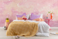 The Twilight Nebula mural in rose and lilac on a nursery wall