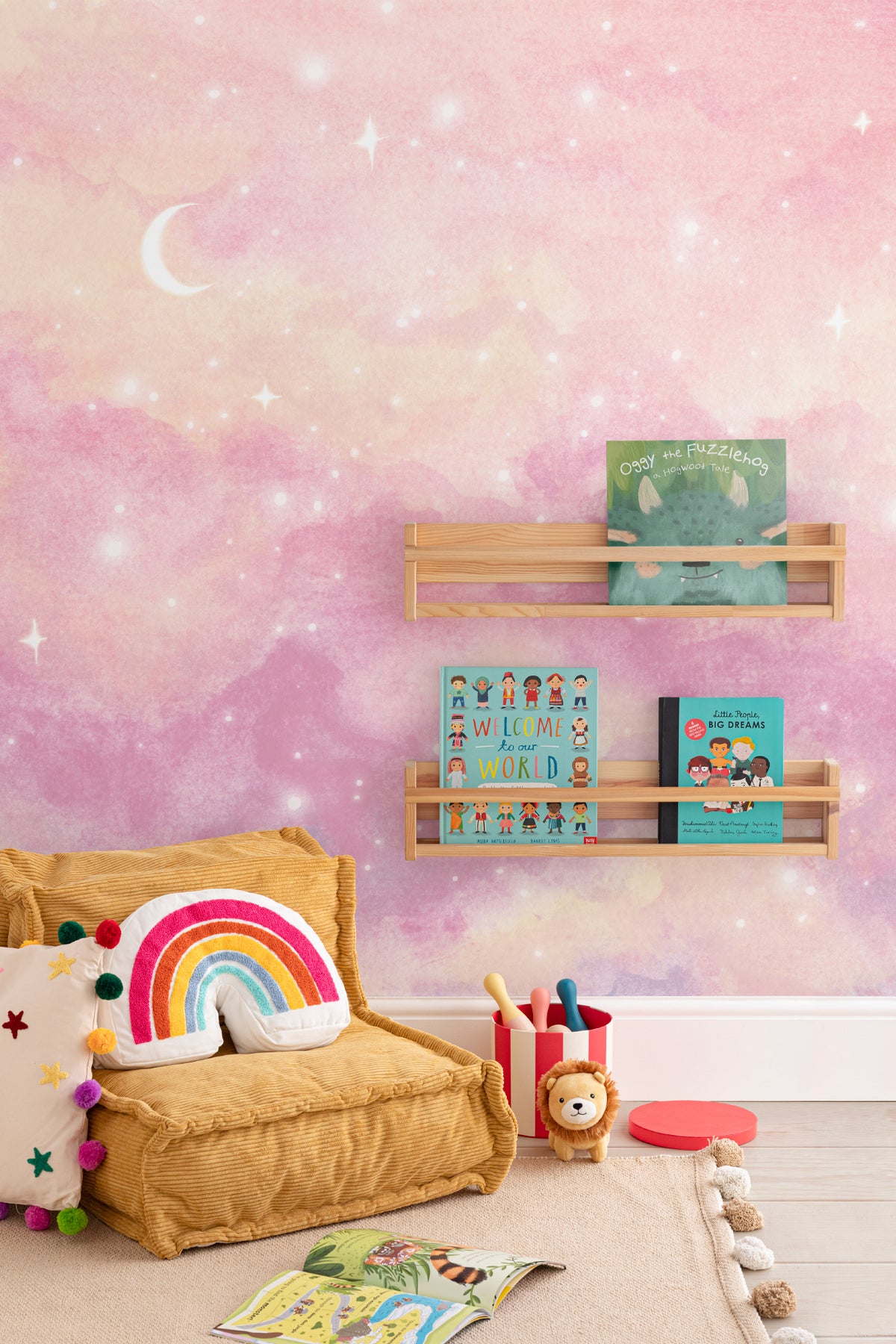 The Twilight Nebula mural in rose and lilac behind a kids' play corner
