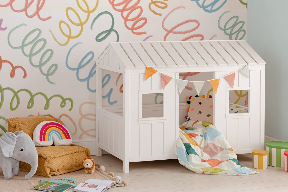The Twirling Coil mural in candy red and blue in a child's bedroom