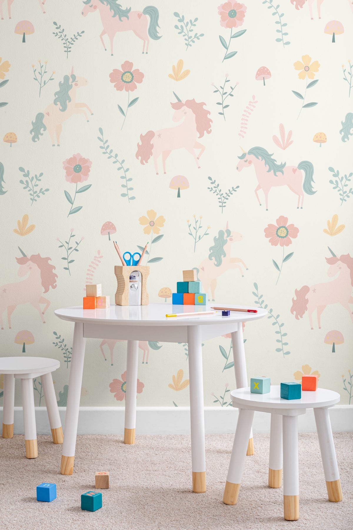The Unicorn Garden wallpaper in soft pastel in a children's room setting