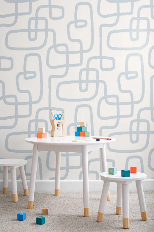 The Wandering Line wallpaper in pale blue behind a desk in a home office