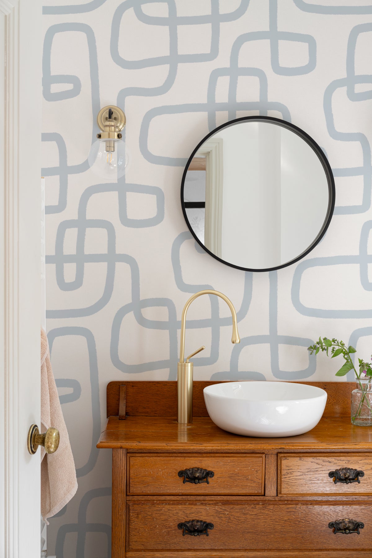 The Wandering Line wallpaper in pale blue in a bathroom